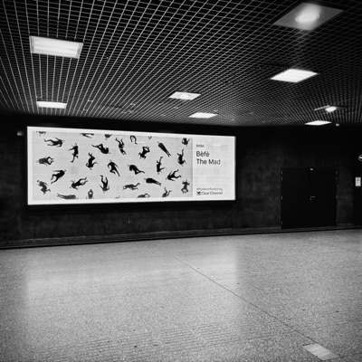 A wide screen carrying the work in an underground concourse