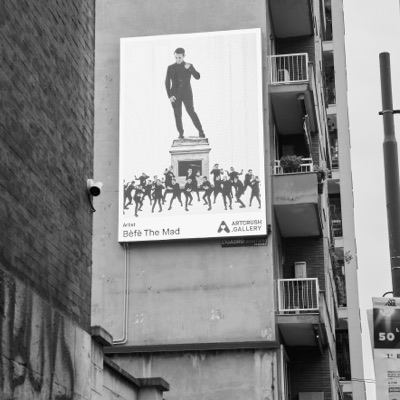A poster of the work across a building facade