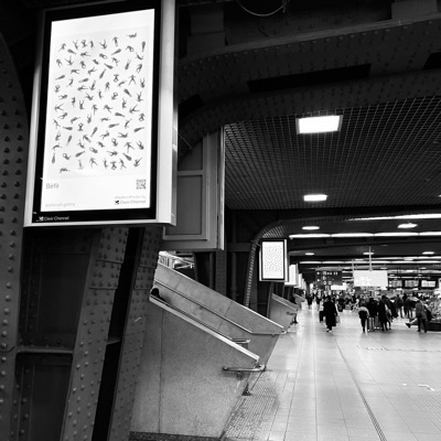 The work on a screen beside a station escalator